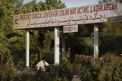 A patient wheels himself across the grounds at Emergency Hospital in Lashkargah, Helmand Province, Afghanistan.
