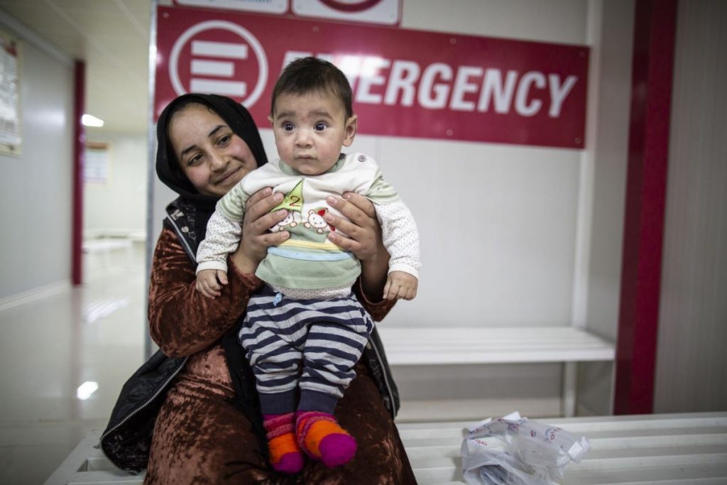 ‘How many children are living here?’ I ask. ‘There are about 11,500 people living in the camp and more than half of them are children.’